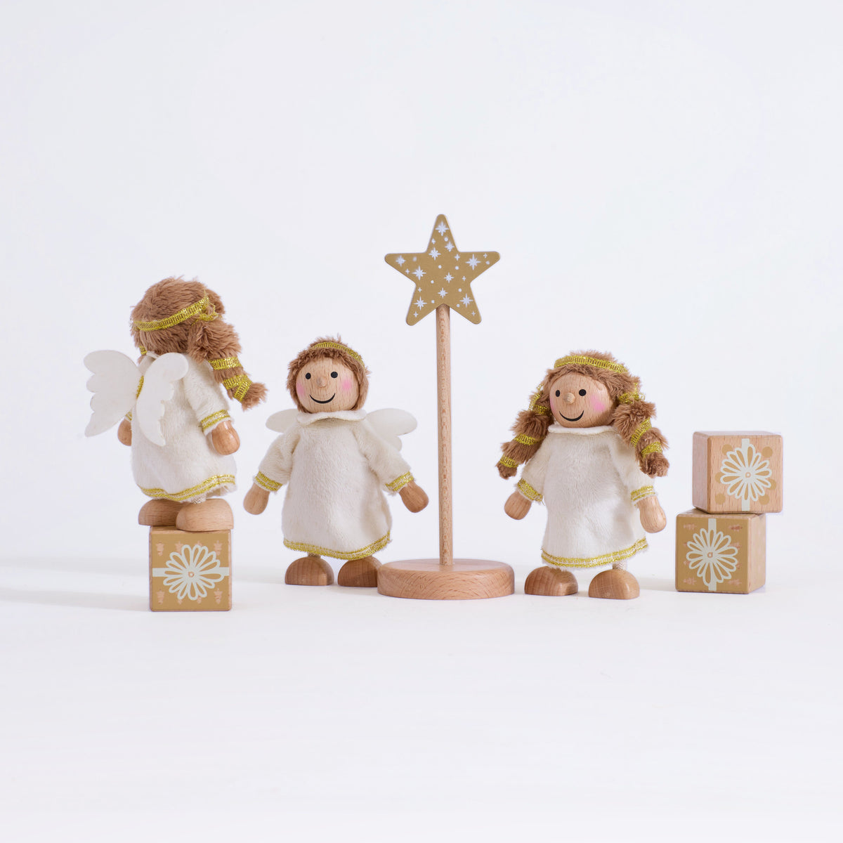 Cherub Angels arranged to show their white wings and gold-trimmed dresses on a grey background