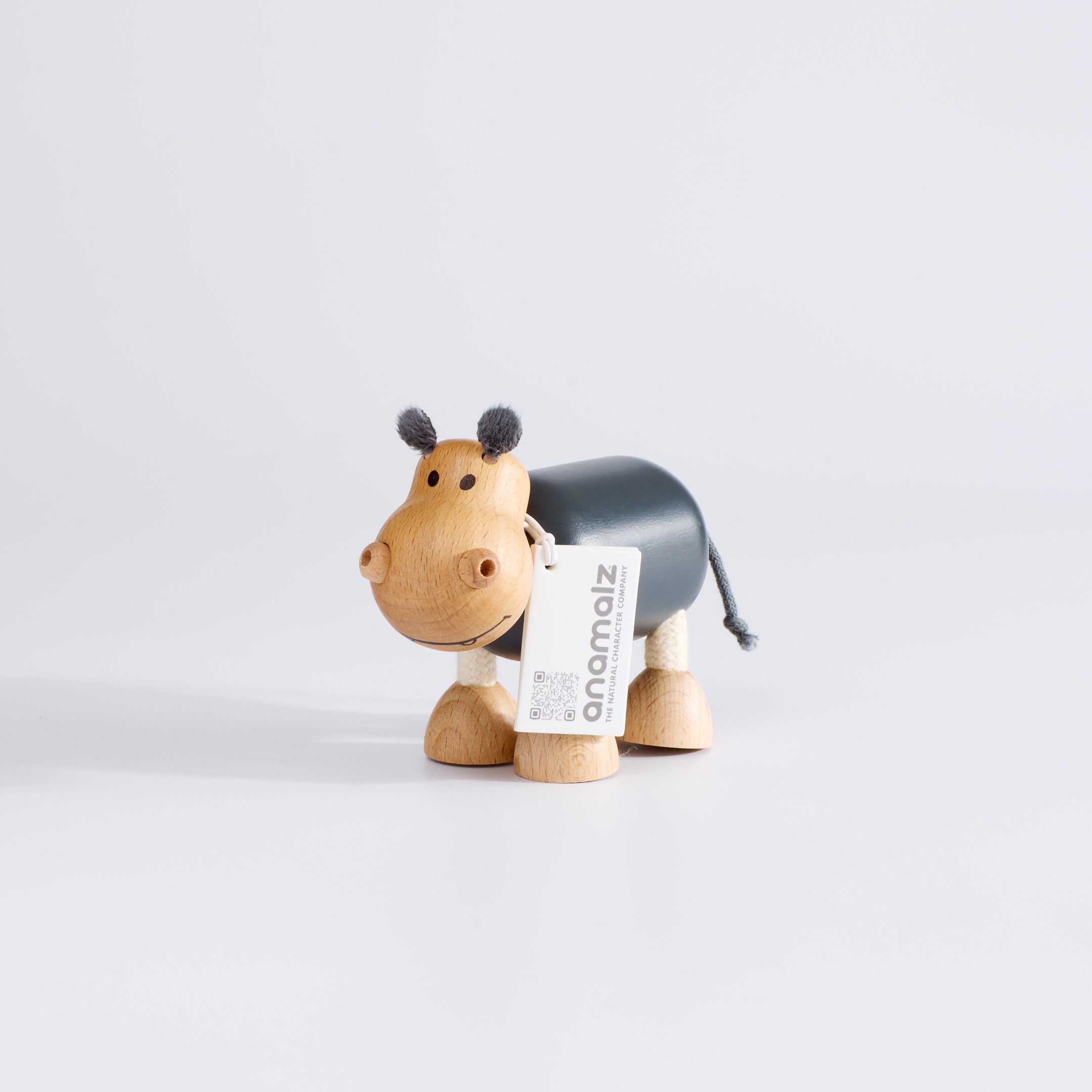 Wooden toy hippo with grey body.