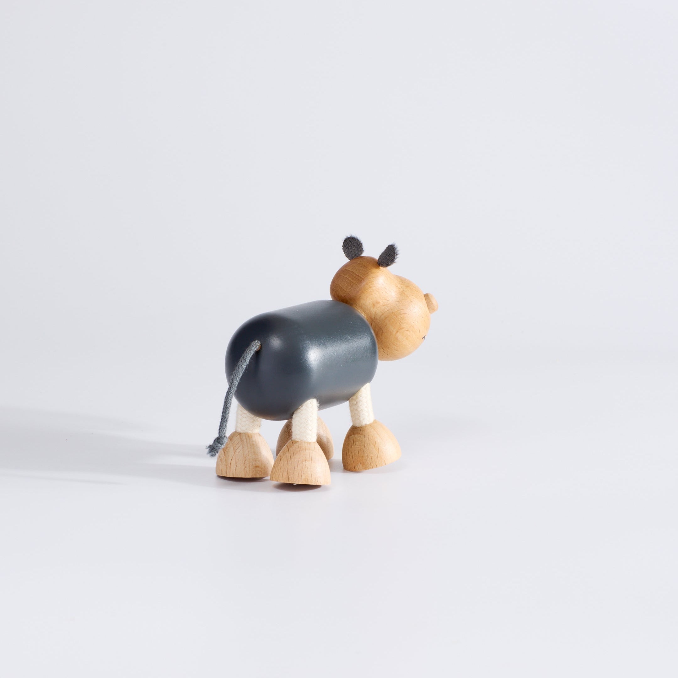 Wooden toy hippo with grey body.