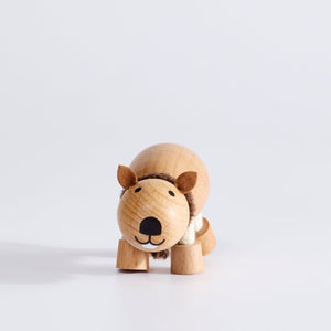 A handcrafted wooden toy wombat with a soft scarf, displayed against a white background.