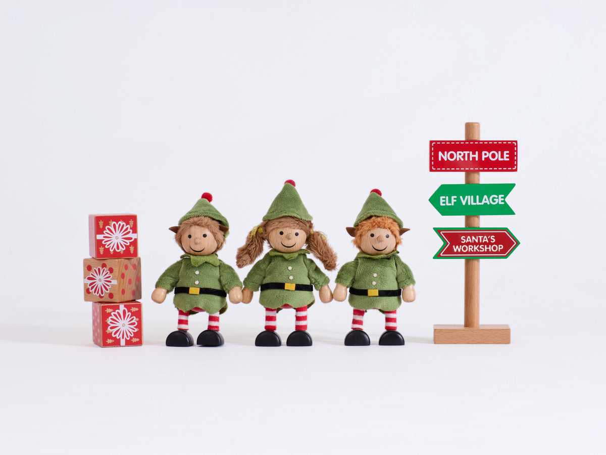 Complete Cheeky Elves set with three elves, three present blocks and corrected direction sign on a grey background