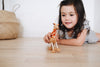 Whimsical eco giraffe toy made from wood and rope, perfect for imaginative play and adventure.