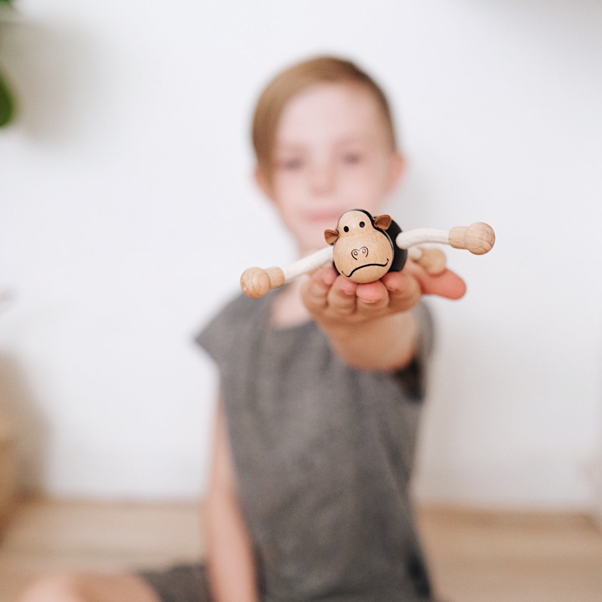 Eco-friendly wooden gorilla toy with flexible arms, perfect for imaginative play and learning.