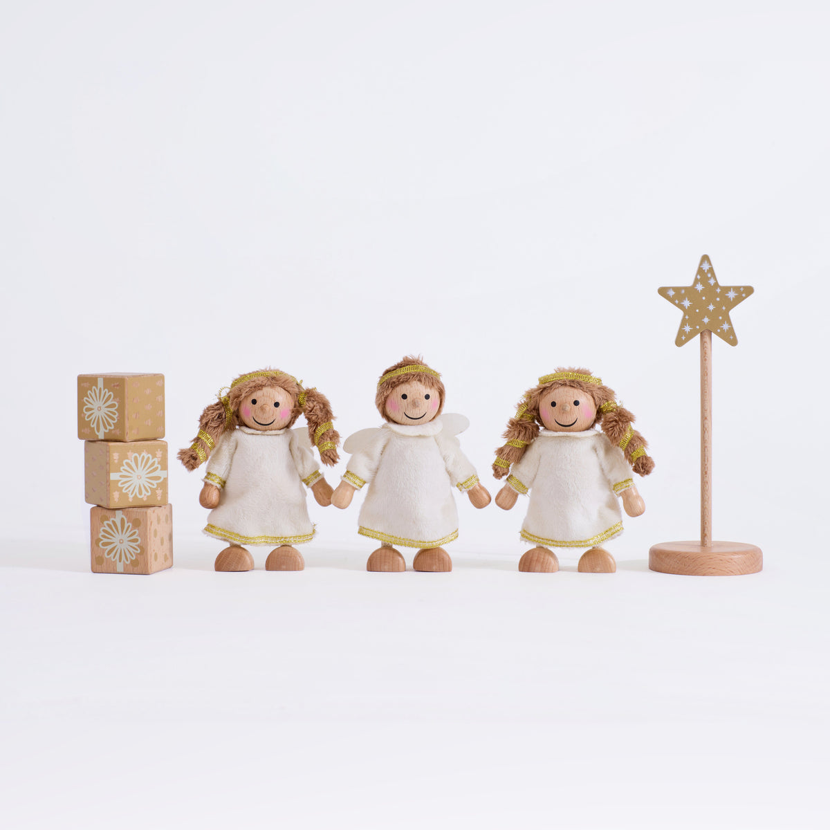 Complete Cherub Angels set with three angels, a star on a stand and three present blocks on a grey background