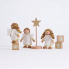 Cherub Angels arranged to show their white wings and gold-trimmed dresses on a grey background
