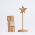 Detail of the Cherub Angels star stand and three wooden present blocks on a grey background