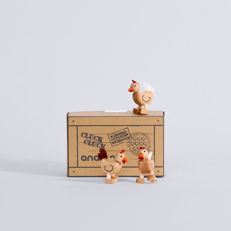 Three Chicken Trio wooden chickens displayed with their box
