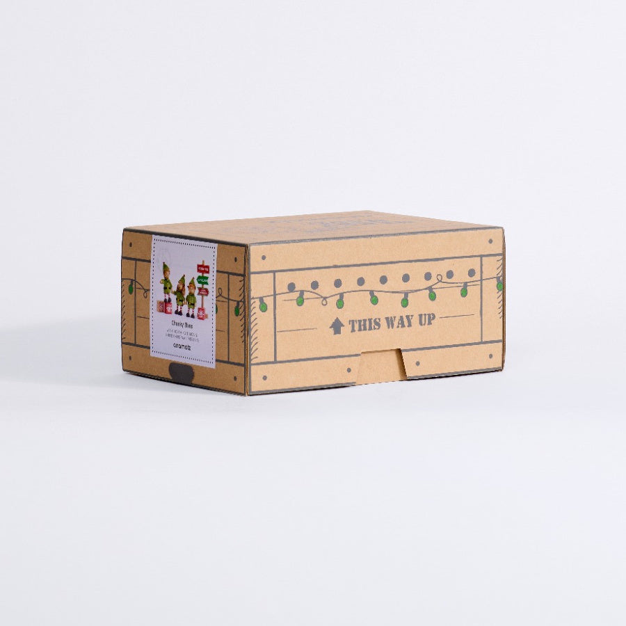 Angled view of the Cheeky Elves gift box showing the product label and festive side panel