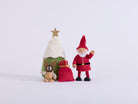 Santa waving beside the Christmas tree, red gift sack and penguin wearing reindeer antlers
