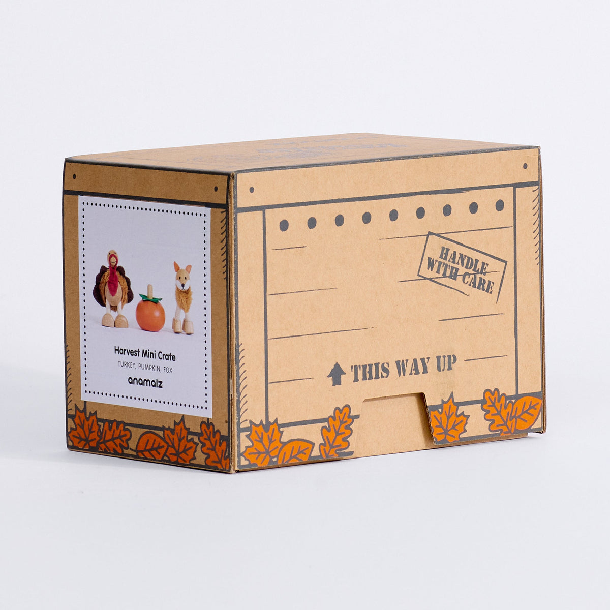Closed Harvest Mini Crate box with turkey, pumpkin and fox product label and orange autumn leaves