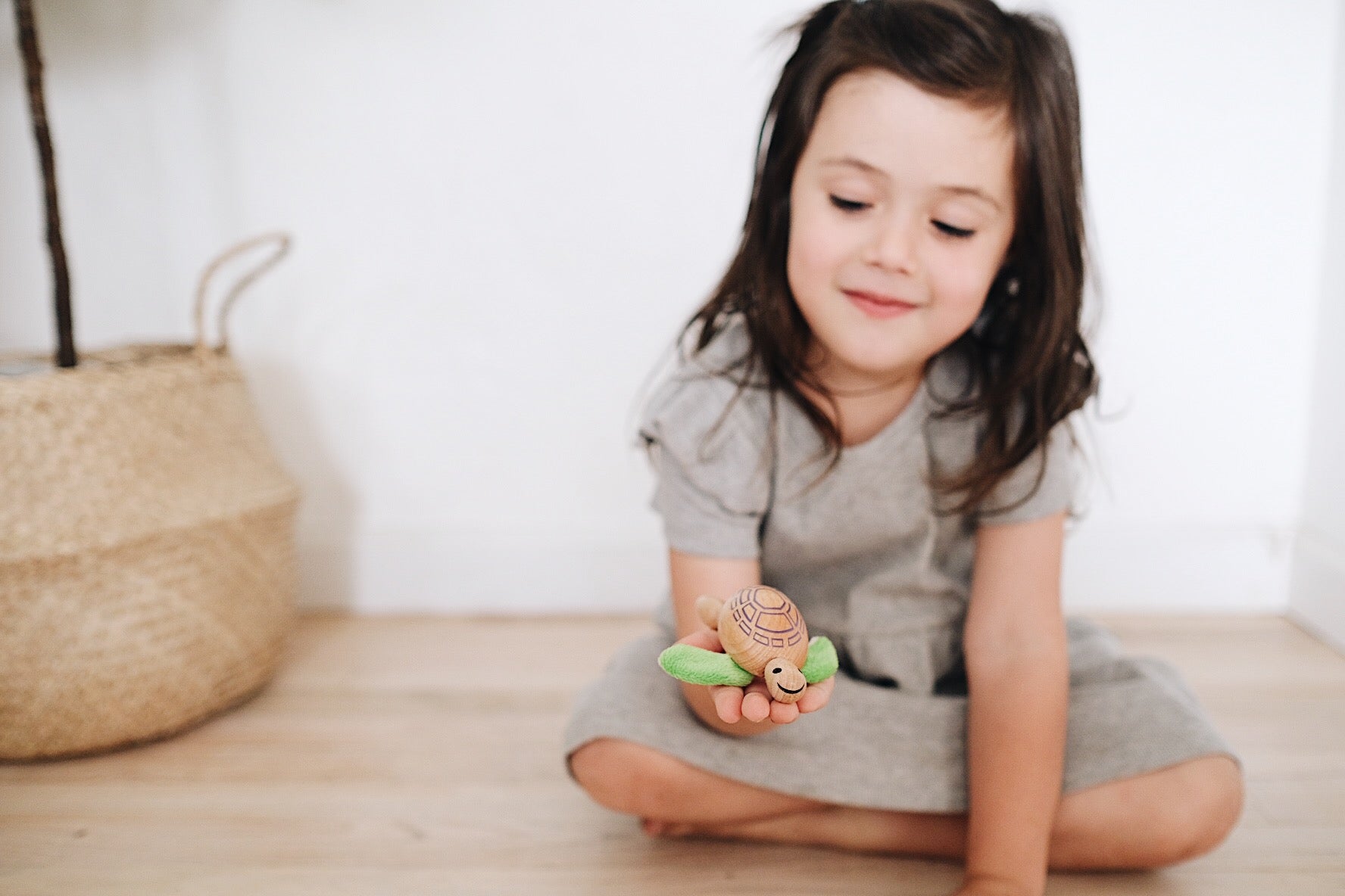 Adorable eco-friendly wooden turtle toy with fabric flippers and a smiling face, perfect for imaginative play and learning.